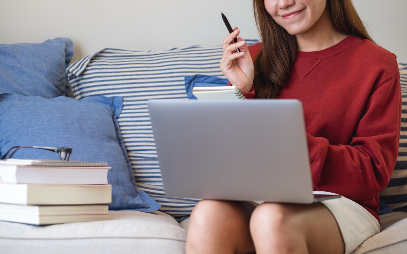 A woman studying on a laptop at home